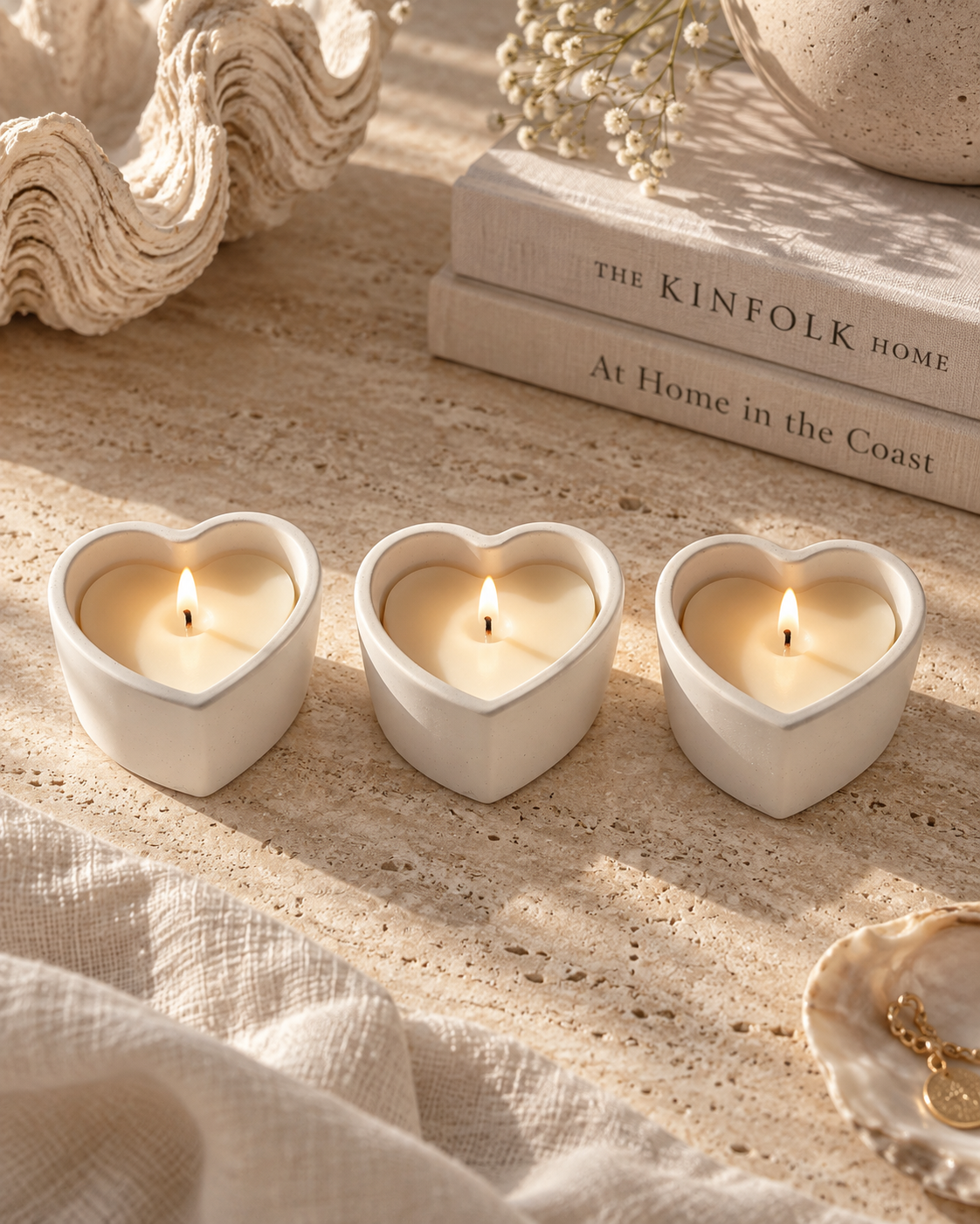 Three lit Stone Heart Candles arranged in a line