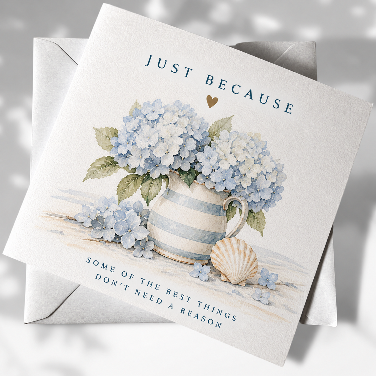 Just Because coastal greeting card with blue hydrangeas in a striped jug and shell illustration