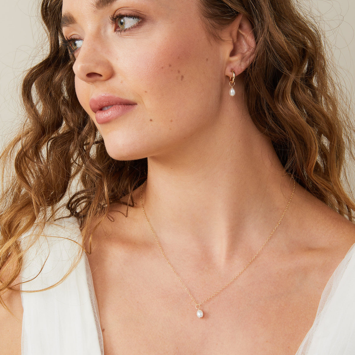 Mini Florence freshwater pearl necklace worn with pearl hoop earrings
